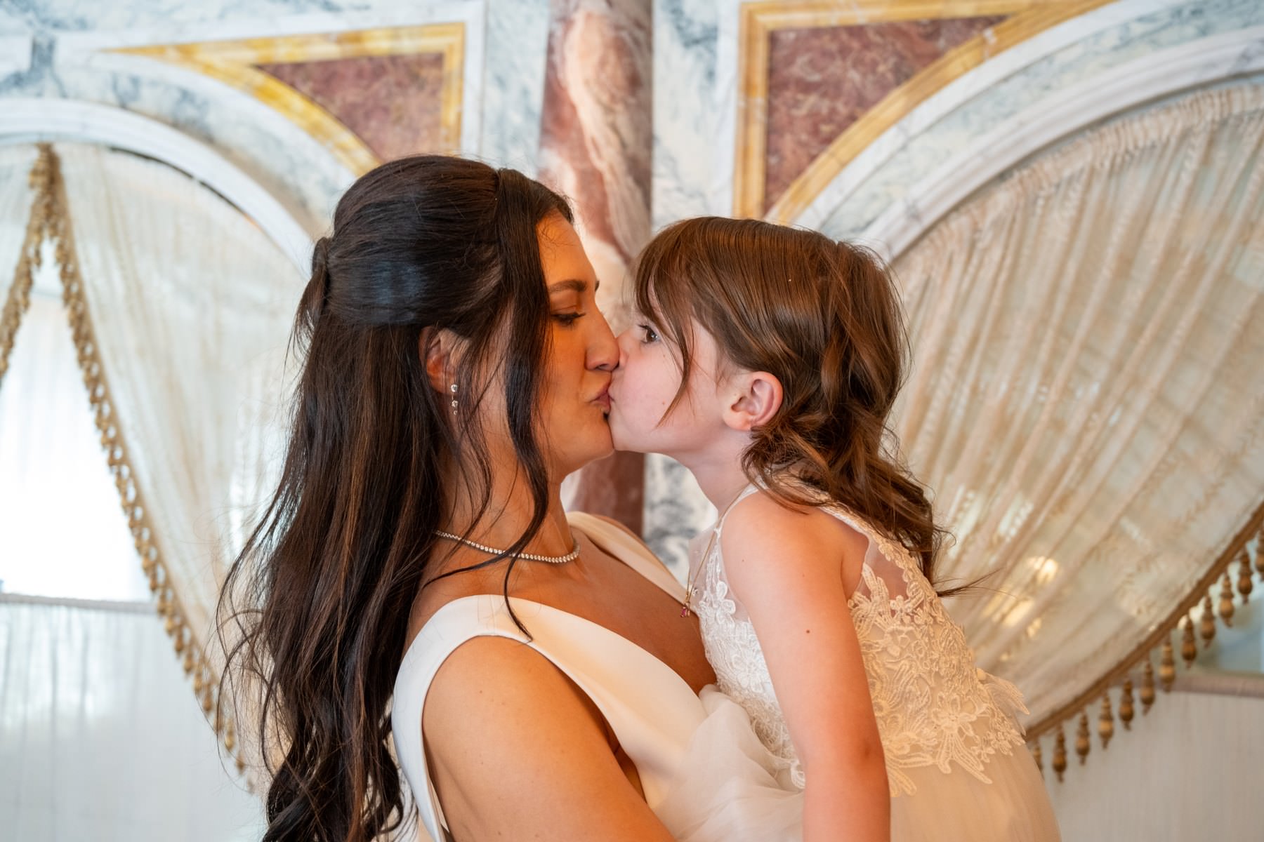 Sam kissing her daughter at the wedding meal at Bacchanalia