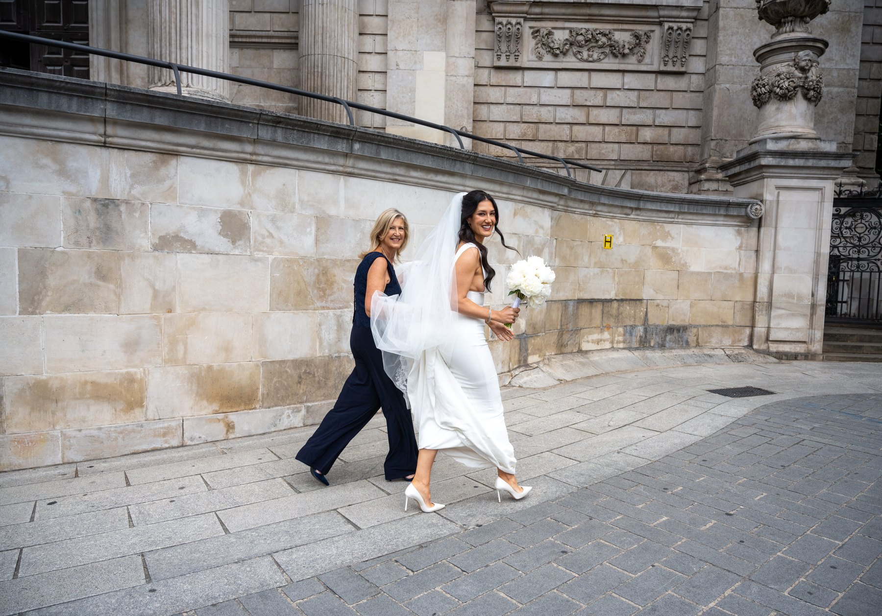Sam and her mum walking along the stone wall beside St Paul's Cathedral