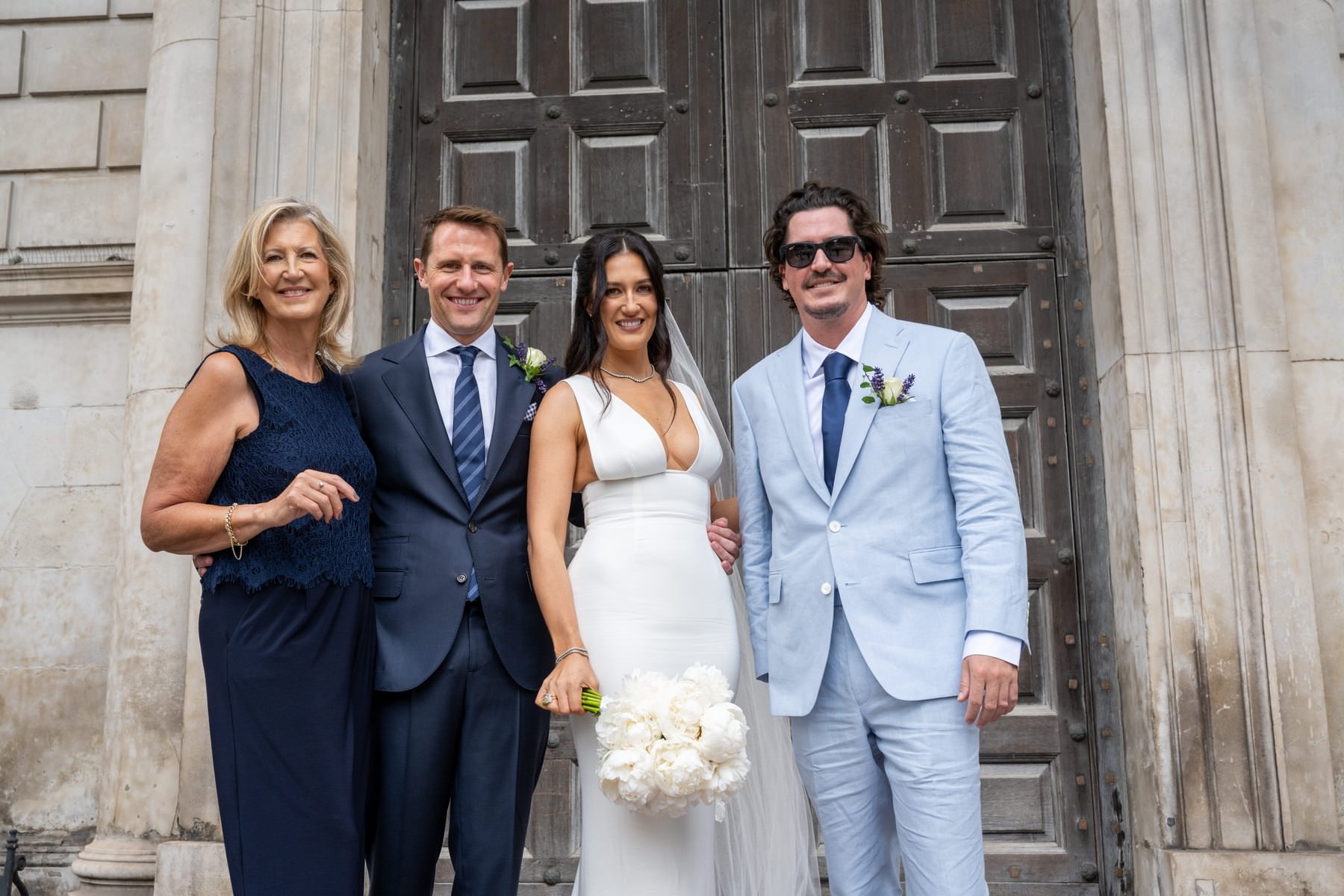 Sam and Matt with family and a friend in front of the great west doors of St Paul's Cathedral